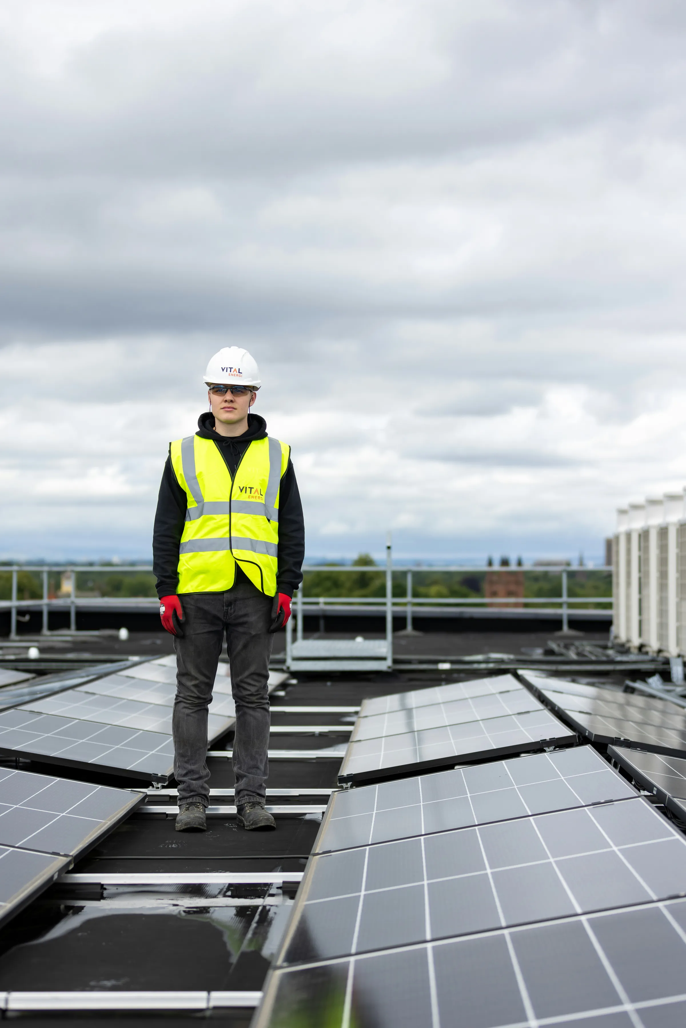 Engineer installing solar panels on a rooftop