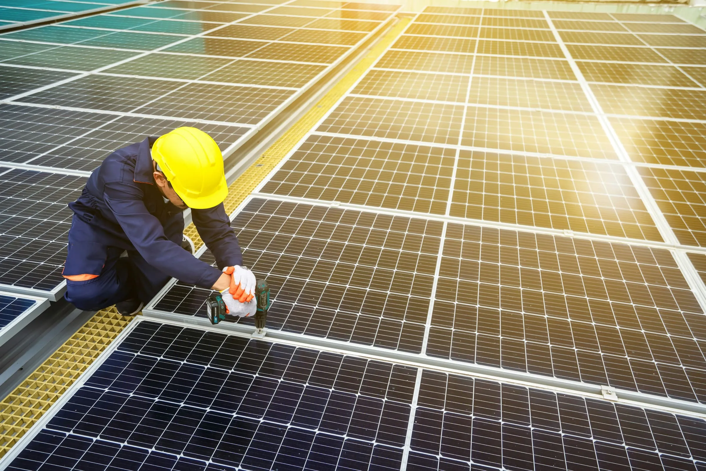 Solar installer working on rooftop panels